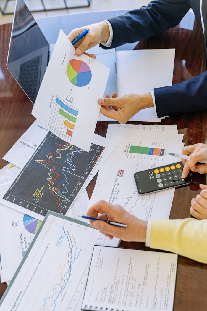 services-03 Business professionals analyzing financial charts and graphs during a meeting.